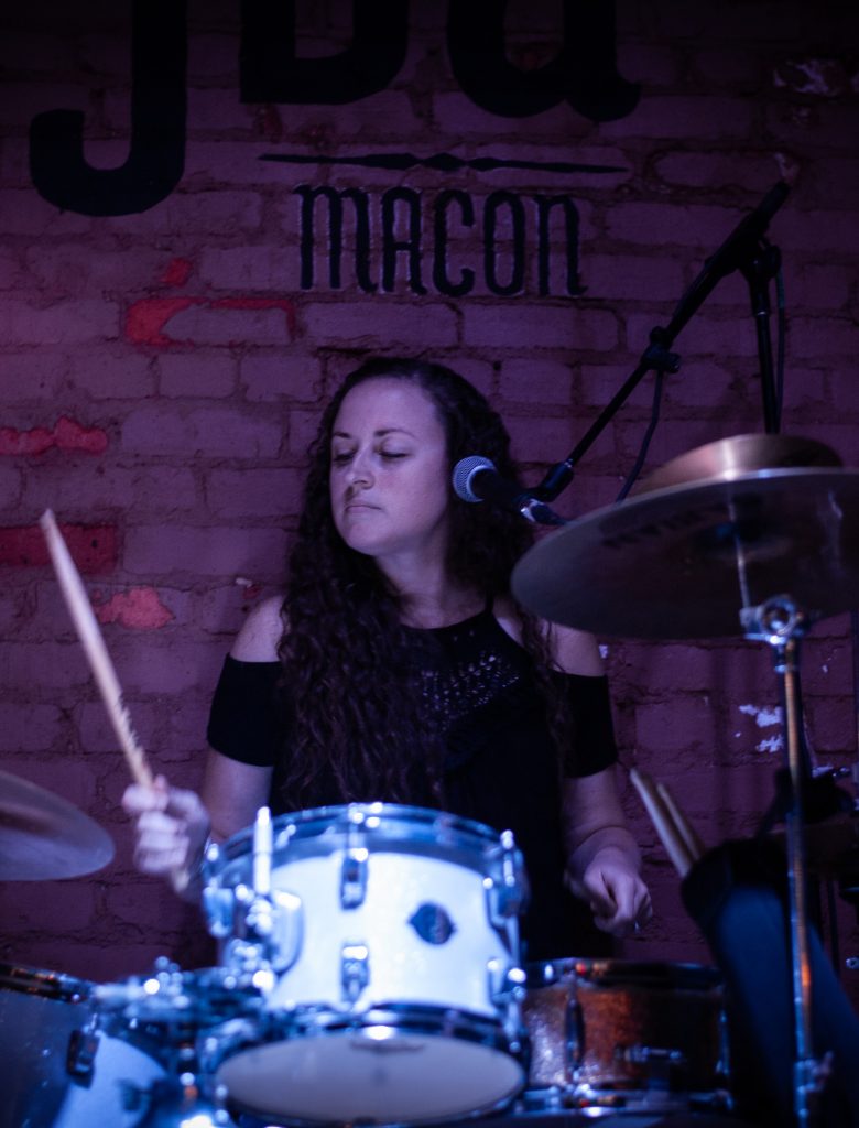 Emily Hall playing drums